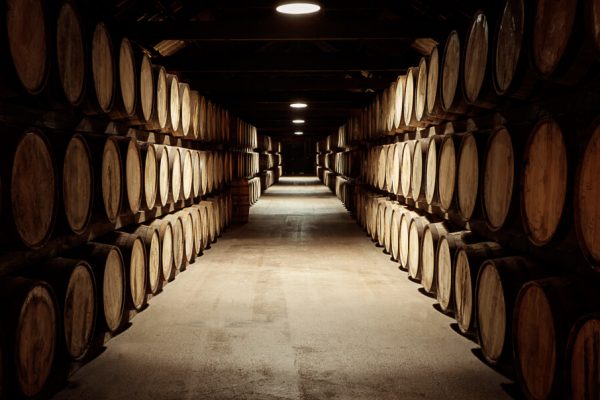 barrels of whiskey all stacked neatly