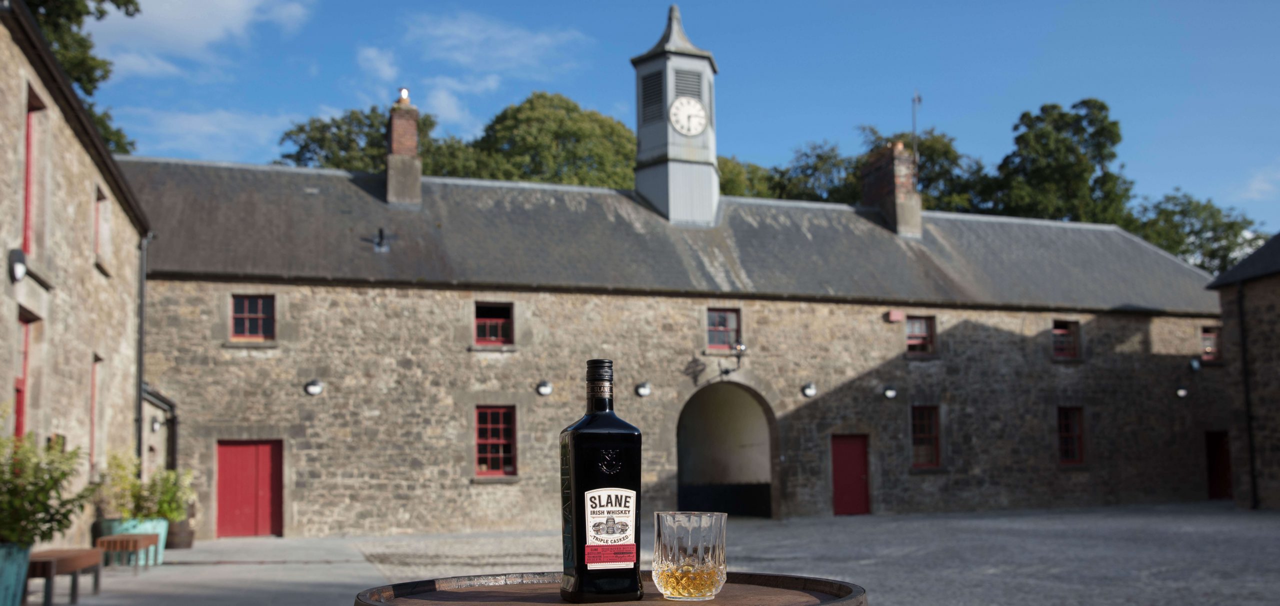 slane exterior with slane whiskey bottle and glass