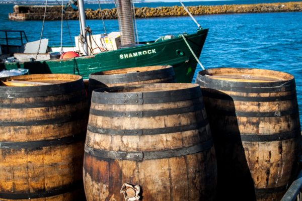 three barrels in front of a boat